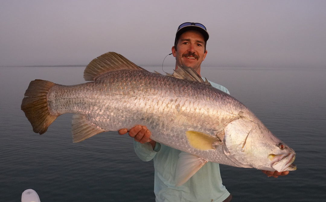 Angler holds a large Barramundi caught using a Fishlogica Icon series rod in Australia